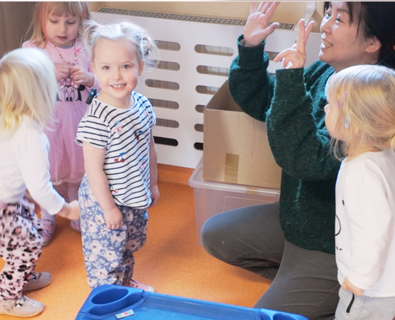 teacher with children in ITSW nursery